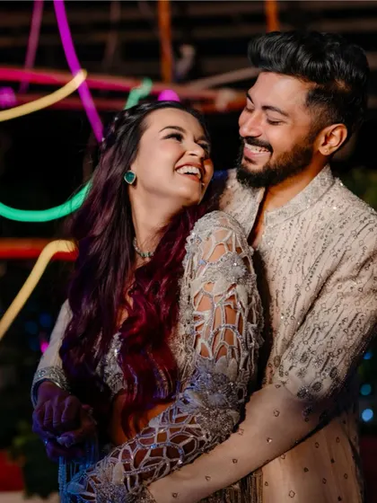 A candid shot of the couple sharing a laugh during their Sangeet. This image captures their genuine connection and the joy of the celebration.