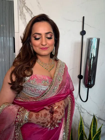 Soft, voluminous curls for a glamorous party look. This style pairs beautifully with a designer saree and statement jewelry.