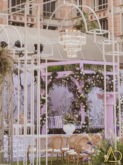 A wider perspective of the enchanting purple garden wedding setup, showing how the mandap integrates with the surrounding decor and guest seating.