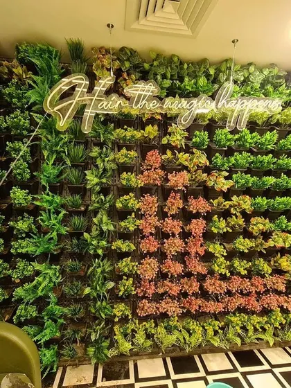 An artificial vertical garden installed in a salon, featuring a custom neon sign. I can create unique patterns and color blocks to match a business's interior design.