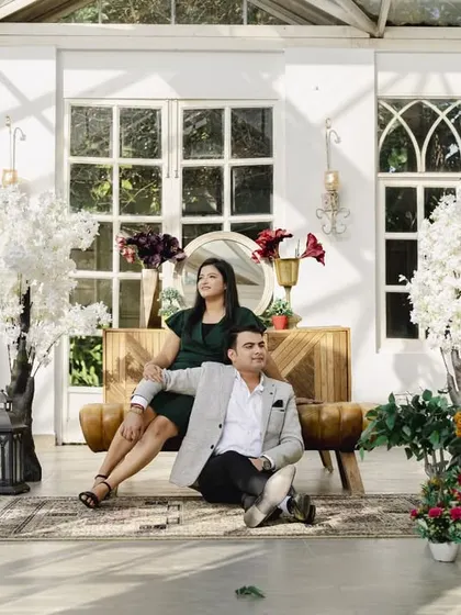 A wider shot of the couple in the elegant glasshouse setting, showing the beautiful decor and lighting we can use to create a stunning pre-wedding album.
