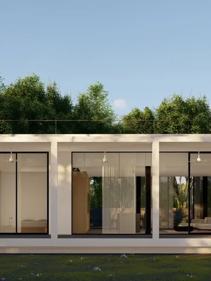 This small farmhouse on the outskirts of Hyderabad features a simple, open-plan design with large roof overhangs. These overhangs provide shade to mitigate solar heat gain and create a semi-open veranda, blurring the line between indoor and outdoor living.