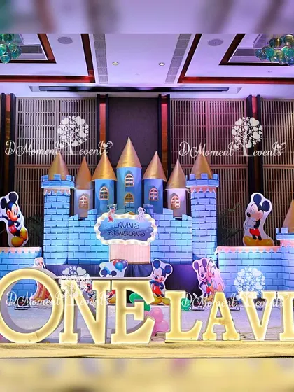 A magnificent Disneyland castle stage setup, featuring Mickey Mouse and other classic Disney characters for a magical first birthday.
