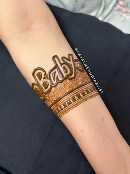 A close up of the "Baby" armband. This is a fun and trendy way to announce your joy. I can customize the font and surrounding patterns to match your style.