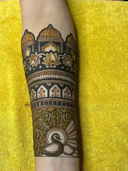 This arm piece combines a palace dome with a beautiful peacock below it, creating a scene inspired by royal Indian art.
