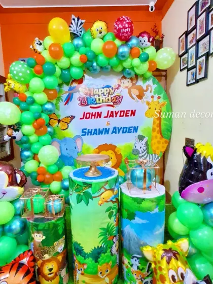 A full view of the jungle-themed decor for a joint birthday party, set up in a home space.