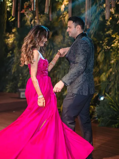 A beautiful, candid shot of a couple lost in their dance, with the groom leading his bride in a gentle turn.