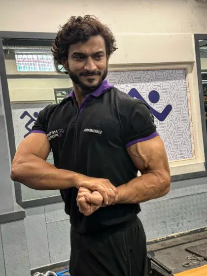 A smiling bicep flex. Enjoying the process is just as important as the result.