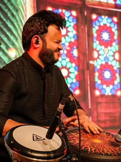 Deep in concentration, playing a complex rhythm on my Djembe. The intricate patterns are essential for creating the right mood for a ghazal performance.