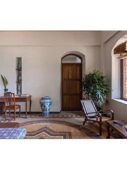 A study area within a larger room, demonstrating how we use antique furniture and thoughtful placement to define functional zones without walls, preserving the open feel of the heritage home.