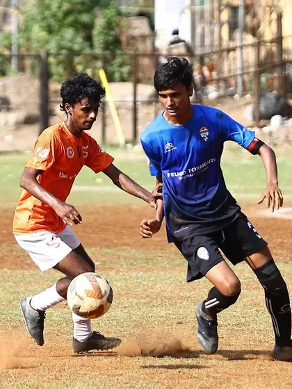 Another shot of a tense one on one battle for possession during the MFA league game.