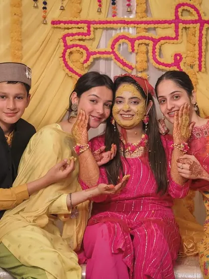The bride posing with her younger family members during the Haldi ceremony.