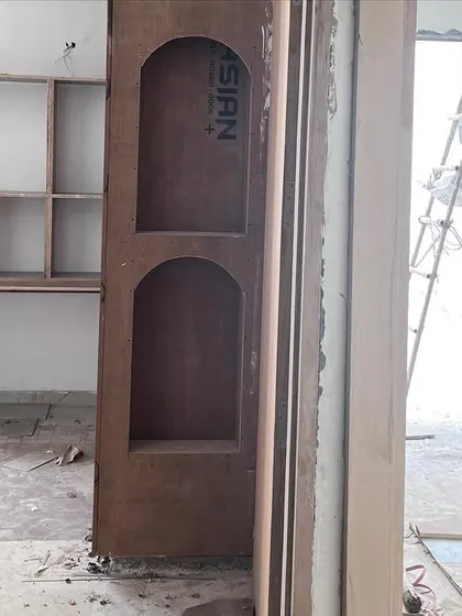 A kids' room during the construction phase. This image shows the raw plywood structure for the wardrobe and study nook, which will later be transformed into a whimsical and functional space.