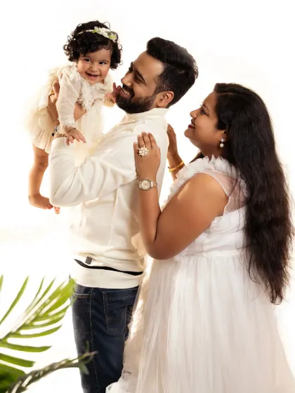A sweet and candid family portrait, capturing the loving interactions between parents and child.