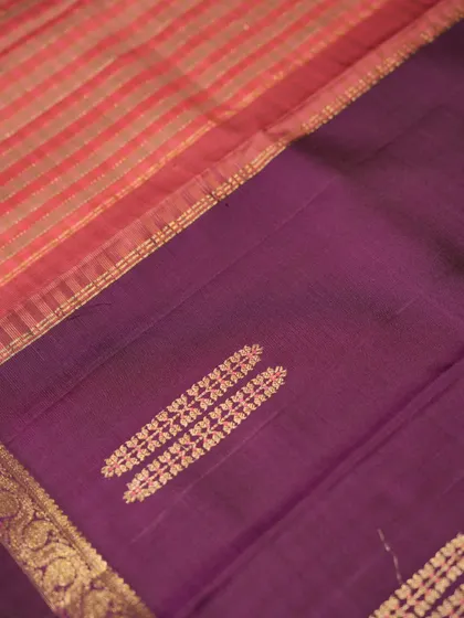 The interplay of the purple body and the pink and gold checked pallu.