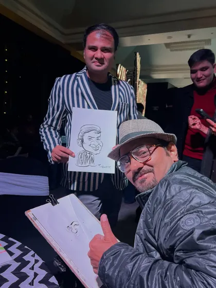 Posing with a happy guest and his new caricature. It’s always a pleasure to see the final result bring a smile.