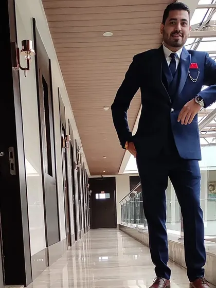 This is a custom three-piece suit, showing how a waistcoat adds another layer of formality. The fit is kept modern and sharp, not boxy.