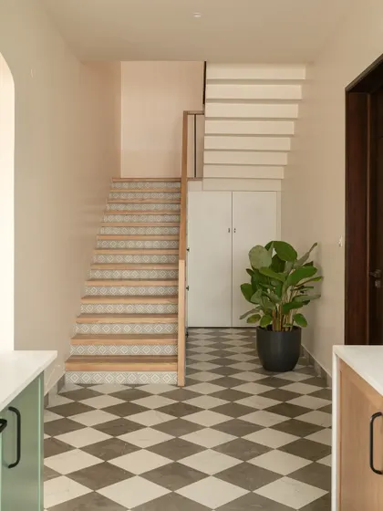 A full view of the staircase, showing the blend of materials that defines the Earthy Hacienda home. The design is an effortless mix of a modern Californian hacienda with simple, earthy Indian rootedness.