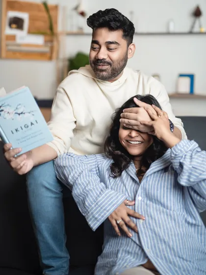 A candid moment of fun and surprise during a couple's maternity shoot. These genuine laughs make for the best memories.