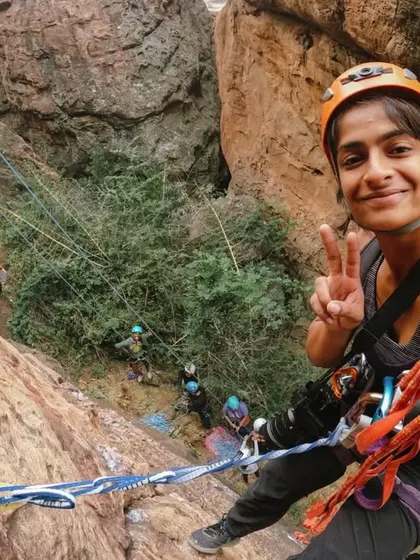 A selfie from the wall! This shot captures the pure joy and sense of accomplishment of being on a rope climb, high above the ground, surrounded by friends.