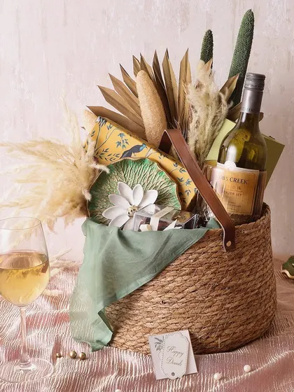 For a rustic yet elegant feel, our Rustic Delight Country hamper is perfect. It includes a bottle of wine, a diffuser set, chocolate barks, and hazelnut cookies in a beautiful basket.