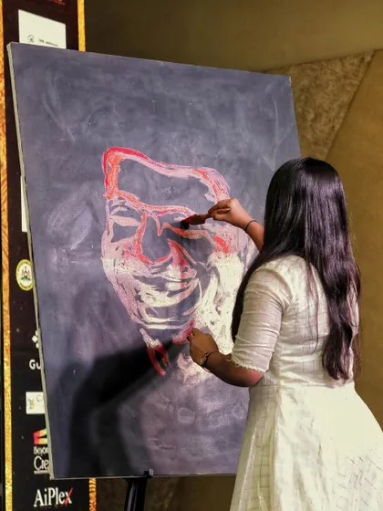 Adding layers and depth to the portrait. Each brushstroke is quick and deliberate, building the features and expression to create a recognizable likeness in minutes.