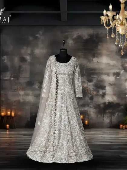 Step into elegance with our exquisite Gray Net Tail Gown featuring delicate floral designs, perfect for making a graceful statement.