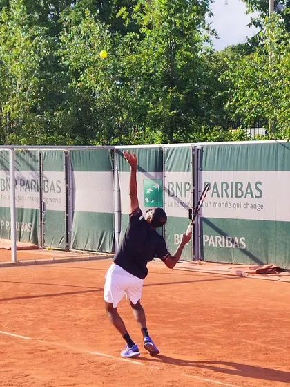 Practicing my serve at Roland Garros. The constant refinement of technique, even at the highest level, is a lesson in itself.