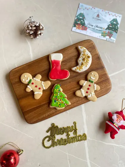 Getting into the festive spirit with our hand-decorated gingerbread cookies. This assortment includes gingerbread men, Christmas trees, and stockings, perfect for holiday gifting.