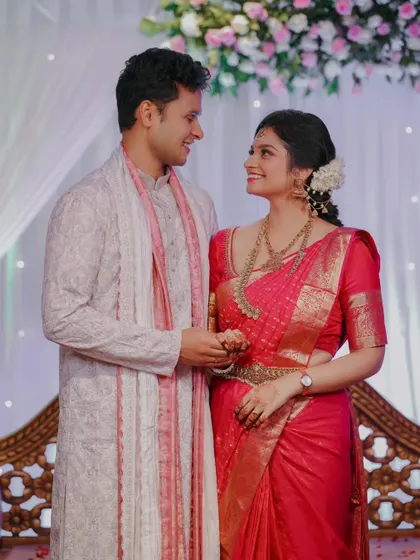A sweet moment between the engaged couple as they look at each other, surrounded by the soft decor of their ceremony.