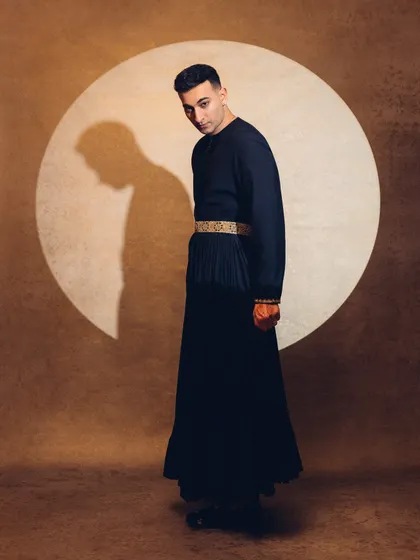 A full-length shot showcasing a dramatic silhouette against a spotlight, highlighting the artistic and theatrical nature of my persona.