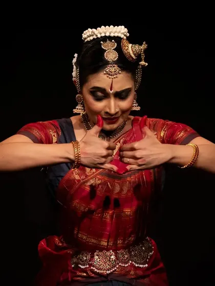 A powerful gesture of holding something precious, a moment of intense focus from the Diaspora Dance Festival.
