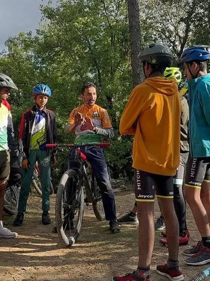 A key part of our workshops is the pre-ride briefing. Here, our coach Rakesh discusses trail features and body positioning with a group of young riders, ensuring everyone understands the technique before we hit the dirt.