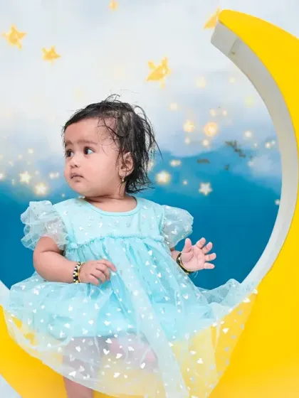 Looking off to the side with a curious expression, this baby is sitting among the clouds and stars. I capture both smiling and contemplative moments, as they are all part of your child's story.
