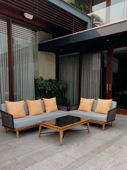 A different angle of the outdoor seating area, showing the modern furniture with vibrant cushions. The stone patio provides a durable and elegant foundation for this comfortable social space.