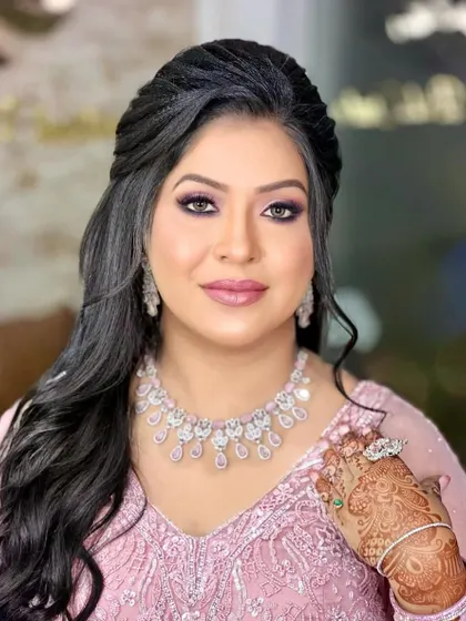 A close-up showing her beautiful smile and the intricate hathphool that adds a touch of tradition to her modern engagement look.