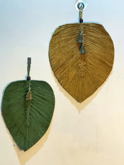 A pair of single, large macrame leaves in olive green and mustard yellow. These are perfect for hanging on their own or as part of a larger gallery wall.