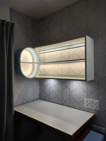 A modern, wall-mounted shelf and desk setup with integrated lighting, creating a sleek and functional workspace within the bedroom.