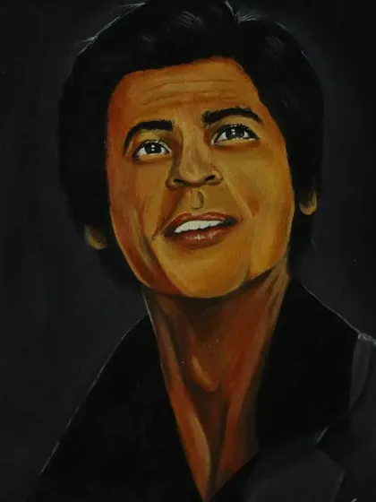 The full view of my SRK portrait on an easel, showing the warm tones and detailed work that went into capturing his likeness.