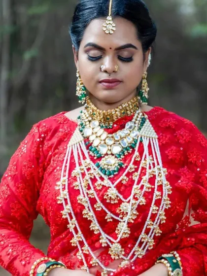 A close-up of the magnificent layered Kundan and pearl necklace. The green accents add a beautiful pop of colour to the intricate design.