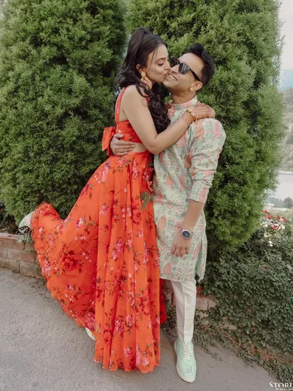 A playful and affectionate kiss on the cheek, capturing the fun and loving dynamic of the couple during their Mussoorie shoot.
