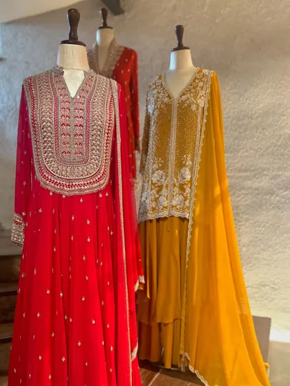 The full view of these elegant red and yellow ensembles. The flowing fabrics and detailed handwork make them perfect for making a graceful statement.