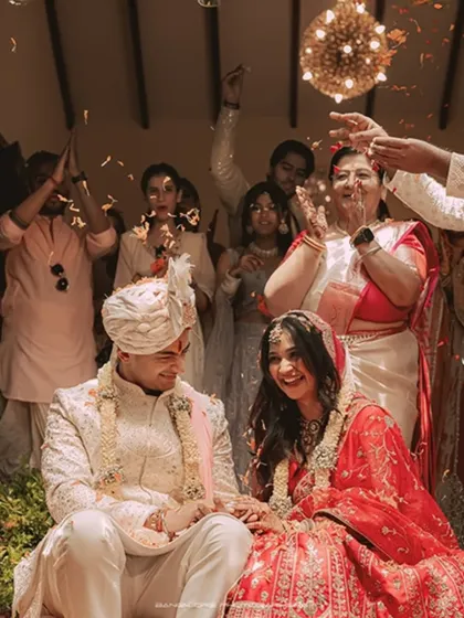 A shower of petals rains down on the happy couple. This action shot is full of energy, celebration, and the pure joy of the moment.