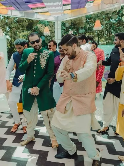 The groomsmen showing off their dance moves at the carnival. These candid shots of the wedding party having fun are essential for capturing the day's energy.