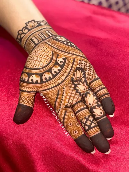 A close up of one hand, showing the detail in the elephant and lotus motifs.