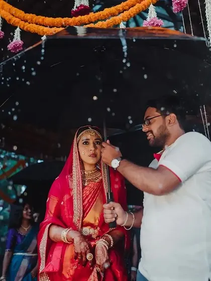 A monsoon wedding story. The rain added a poetic and dramatic element to Roshini's bridal entry, and we ensured the moment was captured beautifully, with umbrellas ready.