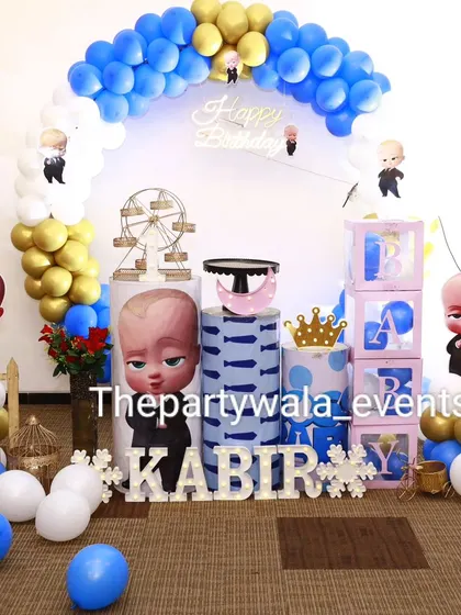 Another look at the Boss Baby first birthday party. The setup includes a mini Ferris wheel prop and a cute picket fence for a charming touch.