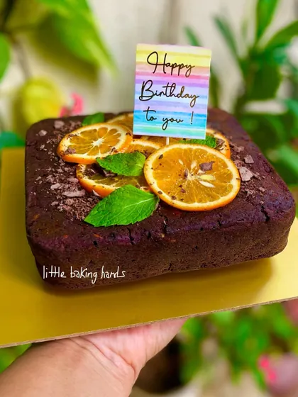 A rich dark chocolate cake sweetened with jaggery and made extra delicious with orange, dates, nuts, and chunky dark chocolate chips. What a wonderful way to celebrate a birthday.