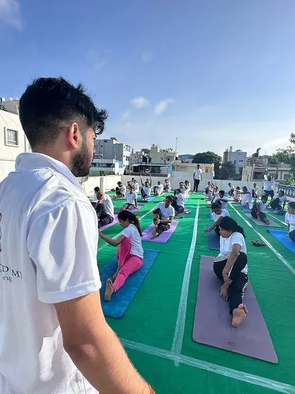 An instructor's view, guiding the class through a series of seated stretches. This perspective highlights the teacher's role in leading the group.