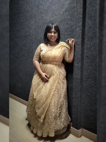 A sweet and simple pose in the golden lehenga, showing a softer side of my personal style.